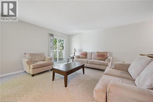 Light-colored walls, textured ceiling, and carpeting throughout - 512 Thorndale Drive, Waterloo, ON 