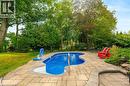 Inground swimming pool lined by mature trees and privacy, fully fenced backyard - 200 Woodview Crescent, Ancaster, ON 