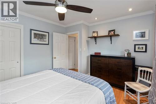 Bedroom 2 with hardwood floor, closet and ample room for dresser, view to front yard - 200 Woodview Crescent, Ancaster, ON 