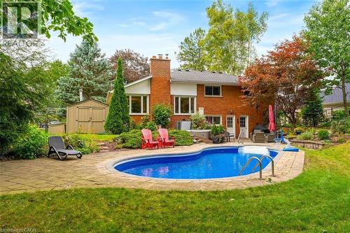 Backyard view highlighting patio surrounding pool and backyard shed - 200 Woodview Crescent, Ancaster, ON 