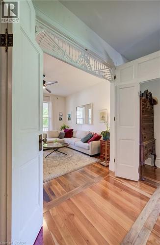 Hardwood flooring, decorative transom detail, paneled interior doors, and a ceiling fan - 59 Allen Street W, Waterloo, ON 