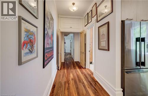 Wood-finish flooring throughout, bright white walls, stainless steel refrigerator, and recessed ceiling lighting - 59 Allen Street W, Waterloo, ON 