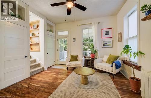 Wood-finish flooring throughout, integrated built-in shelving, two large windows, and a glass-paneled door - 59 Allen Street W, Waterloo, ON 