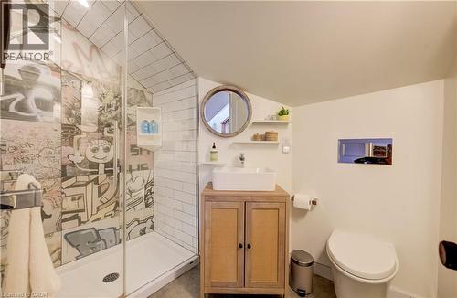 Glass-enclosed shower with subway tile and graphic-patterned wall - 59 Allen Street W, Waterloo, ON 