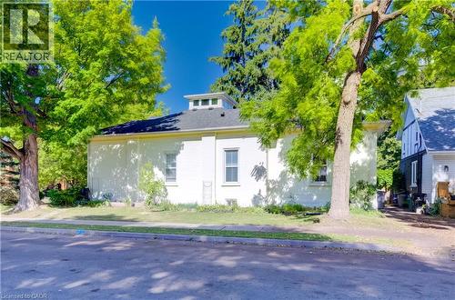Single-story residence with a dark shingle roof and a cupola feature - 59 Allen Street W, Waterloo, ON 
