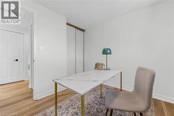 Bright room featuring wood-finish flooring, white baseboards, and a neutral wall color - 