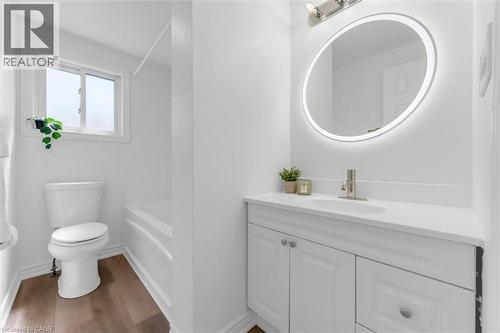 Bathroom featuring a white vanity with paneling detail and a white countertop - 49 Grove Avenue, St. Catharines, ON 