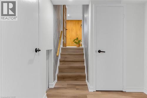 Modern staircase featuring wood-finish treads and a light wood handrail - 49 Grove Avenue, St. Catharines, ON 
