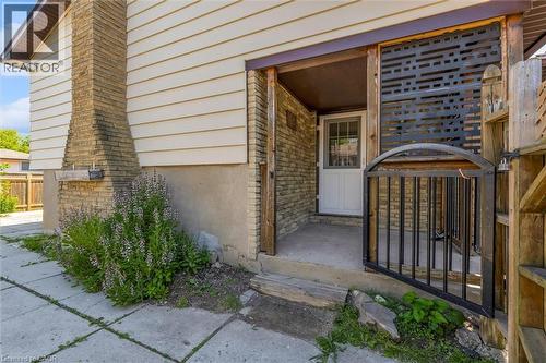 Covered entry with white paneled door - 49 Grove Avenue, St. Catharines, ON 