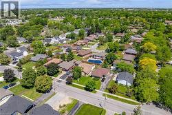 Residential neighborhood featuring mature trees and paved streets - 