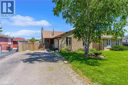 Exterior featuring brick construction, a gabled roofline, and a driveway - 49 Grove Avenue, St. Catharines, ON 