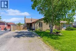Exterior featuring brick construction, a gabled roofline, and a driveway - 
