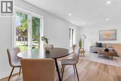 Open-concept living area with light wood-finish flooring - 