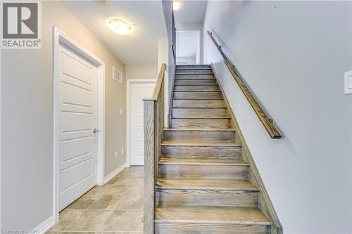Wood-finish staircase with coordinating handrail - 212 Ellen Davidson Drive, Oakville, ON 