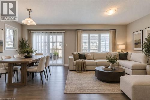 Wood-finish flooring throughout, with a sliding glass door leading to an outdoor space - 212 Ellen Davidson Drive, Oakville, ON 