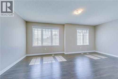 Wood-finish flooring, recessed lighting, and multiple windows with blinds - 212 Ellen Davidson Drive, Oakville, ON 