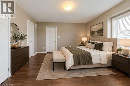 Primary Bedroom Suite featuring hardwood flooring, warm neutral wall finishes, recessed ceiling lighting, and dual nightstands with attached task lighting - 212 Ellen Davidson Drive, Oakville, ON 