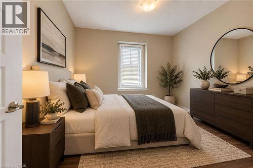 Primary Bedroom featuring neutral wall finishes, wood-finish nightstands with integrated task lighting, a horizontal round mirror, and natural light from a multi-pane window - 212 Ellen Davidson Drive, Oakville, ON 