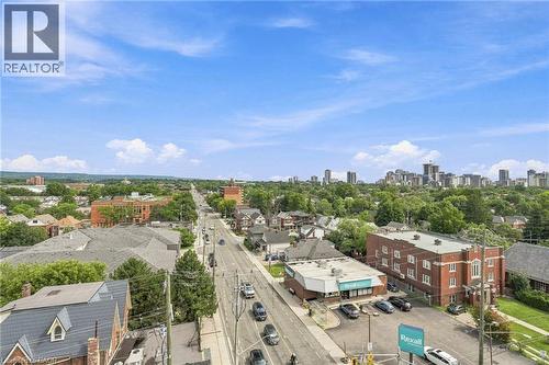 Expansive urban landscape featuring a clear sky, city skyline, tree-lined streets, and commercial buildings - 427 Aberdeen Avenue Unit# 105, Hamilton, ON 