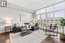 Expansive window wall with plantation shutters, dark wood-finish flooring, and recessed lighting - 427 Aberdeen Avenue Unit# 105, Hamilton, ON 