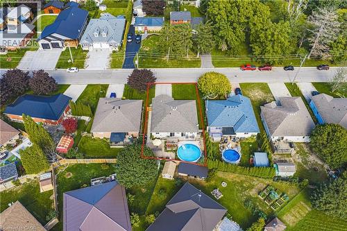 Paved driveway, attached garage, private backyard with an inground pool, and mature landscaping - 915 St George Street, Port Dover, ON 