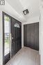 Entryway featuring a decorative transom window above the door, side light window, flush mount ceiling light fixture, bi-fold closet doors, and tiled flooring - 70 Fiddlers Green Road Unit# 74, London, ON 