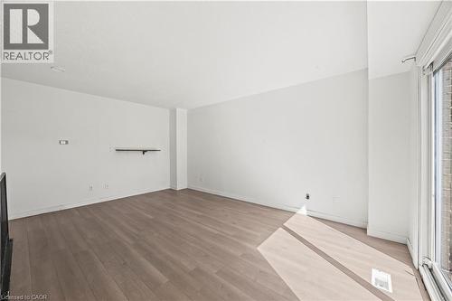 Wood-finish flooring throughout, white painted walls, and a built-in wall shelf - 70 Fiddlers Green Road Unit# 74, London, ON 