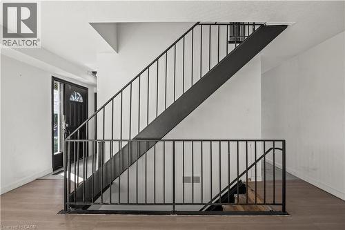 Metal baluster staircase with wood-finish flooring - 70 Fiddlers Green Road Unit# 74, London, ON 