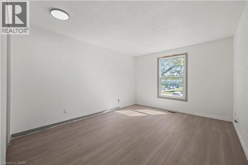 Recessed ceiling light, white painted walls, wood-finish flooring, and a large window - 70 Fiddlers Green Road Unit# 74, London, ON 