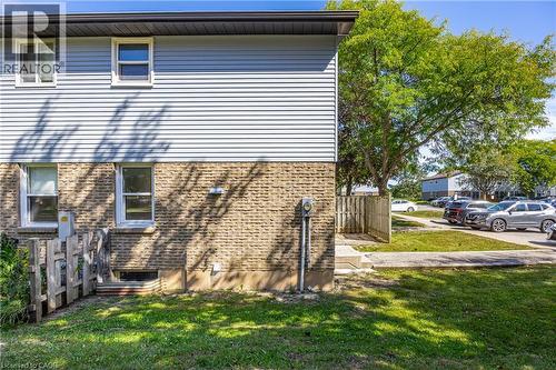 Light blue horizontal siding and brick exterior - 70 Fiddlers Green Road Unit# 74, London, ON 