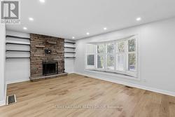 Living room with FP and bow window. - 