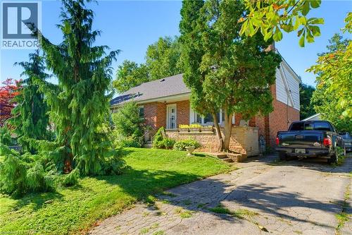 Brick exterior with white siding accents and a pitched roof - 940 Harvey Place, Halton, ON 