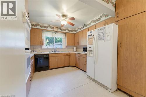 Kitchen featuring wood-finish cabinetry, a ceiling fan, and a window above the sink - 940 Harvey Place, Halton, ON 