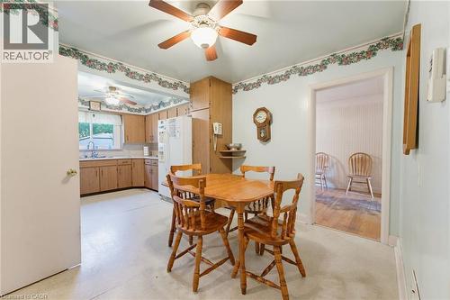 Kitchen featuring wood-finish cabinetry, built-in refrigerator, and ceiling fan - 940 Harvey Place, Halton, ON 