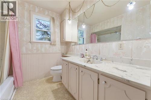 Bathroom featuring a built-in vanity with a countertop, integrated sink, and dual-handle faucet - 940 Harvey Place, Halton, ON 