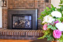 Brick fireplace with a metal insert and decorative wrought iron detailing - 