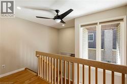 Hardwood flooring, recessed lighting, and a contemporary ceiling fan - 