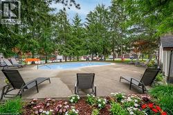 Swimming pool with a concrete surround, surrounded by mature trees - 