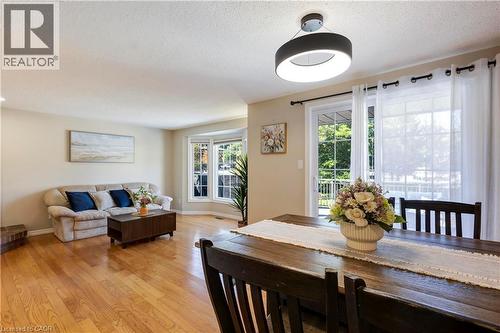 Hardwood flooring, bay window, sliding glass door, modern ceiling light fixture, and neutral wall tones - 475 Beechwood Drive Unit# 4, Waterloo, ON 