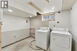 Utility area featuring concrete flooring, exposed drywall, recessed lighting, and a window - 