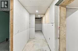 Interior space featuring installed gypsum wallboard, exposed wood framing, and recessed ceiling lighting - 