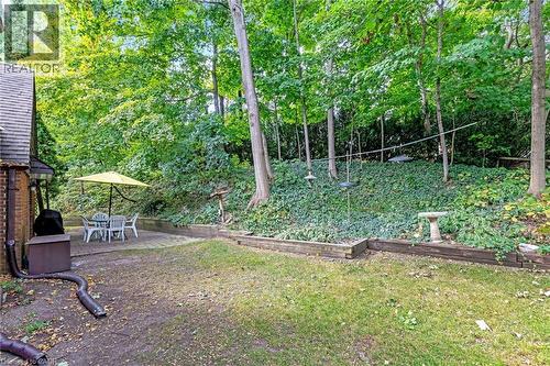 Patio area featuring a concrete surface and dense tree canopy - 12 Mullen Place, Glen Williams, ON 
