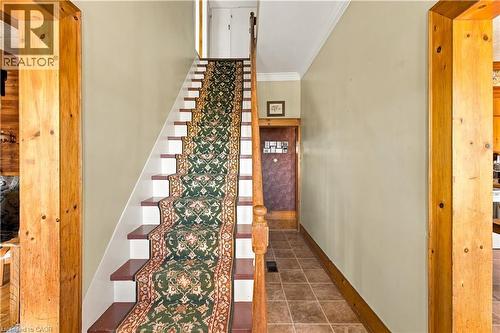 Tiled entryway with wood-finish flooring extending into the hallway - 2744 Bleams Road, New Hamburg, ON 