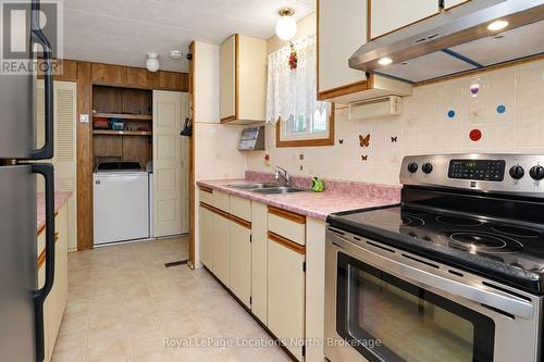 Galley-style kitchen (with nearby laundry room) - 16 Sinclair Avenue S, Wasaga Beach, ON 