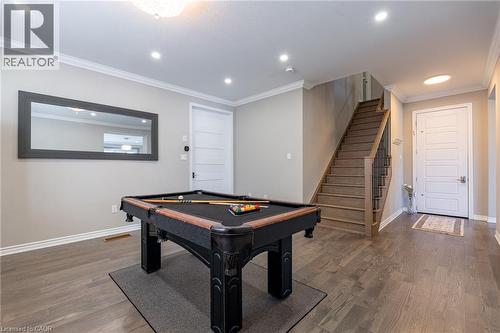 Wood-finish flooring, recessed lighting, crown molding, paneled interior doors, and a wood staircase with metal balusters - 455 Equestrian Way, Cambridge, ON 