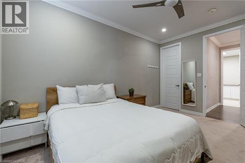 Crown molding accentuates the ceiling, complemented by recessed lighting and a ceiling fan - 455 Equestrian Way, Cambridge, ON 