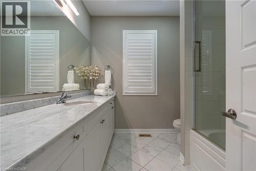 Extended vanity with a light-toned countertop, white cabinetry, undermount sink, and polished chrome faucet - 455 Equestrian Way, Cambridge, ON 