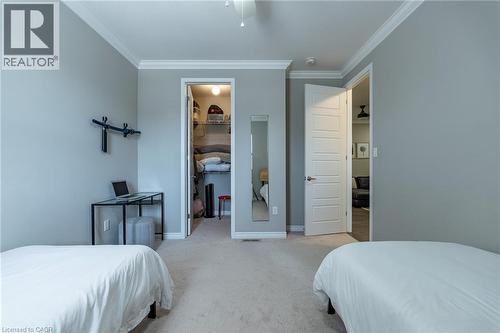 Neutral toned walls, crown molding, paneled interior doors, and carpeted flooring - 455 Equestrian Way, Cambridge, ON 