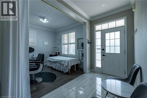 Entry area featuring a solid panel door with frosted glass inserts, a transom window, and a sidelight - 455 Equestrian Way, Cambridge, ON 