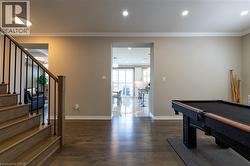 Wood-finish flooring throughout, with recessed lighting and crown molding - 